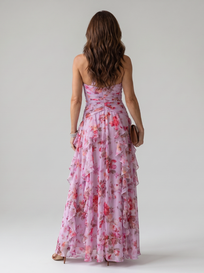 Pink floral maxi dress with halter back and ruched waist, flowing tiered ruffles