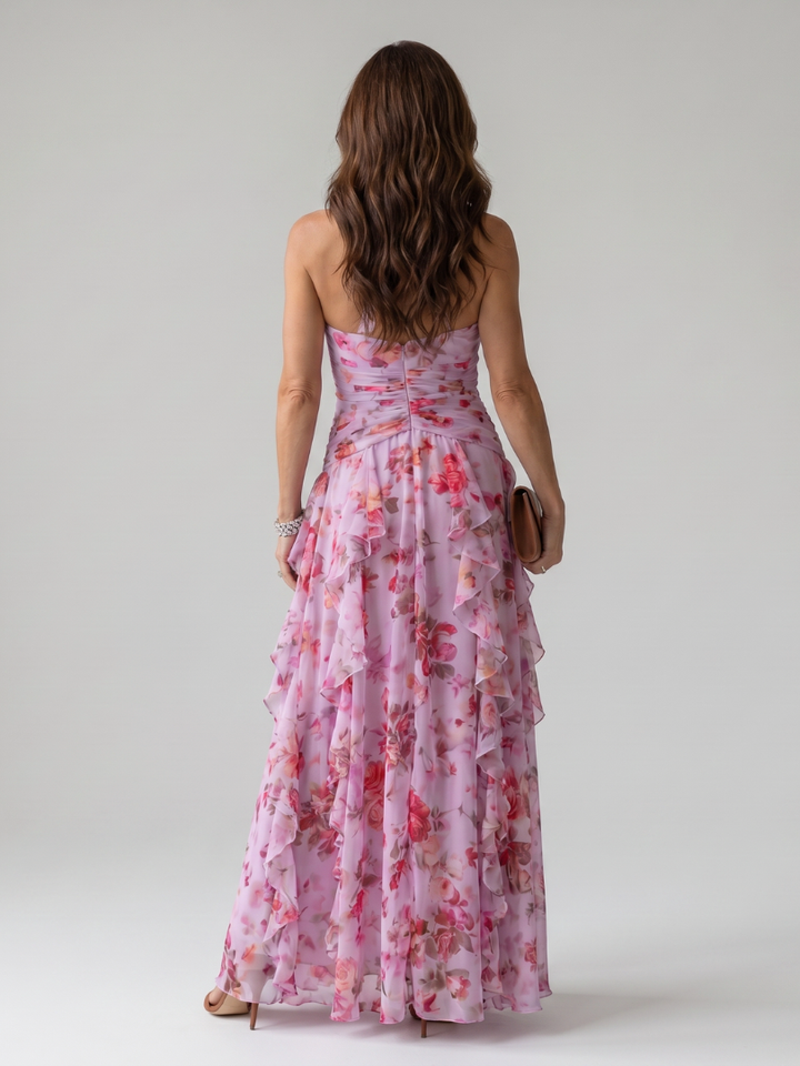 Pink floral maxi dress with halter back and ruched waist, flowing tiered ruffles