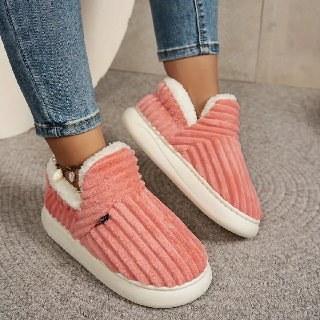 Pink comfort slippers on white soles with fluffy lining and ribbed upper texture
