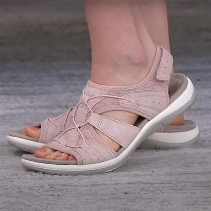 Pale pink orthopaedic sandals with adjustable straps, open toe, and white sole