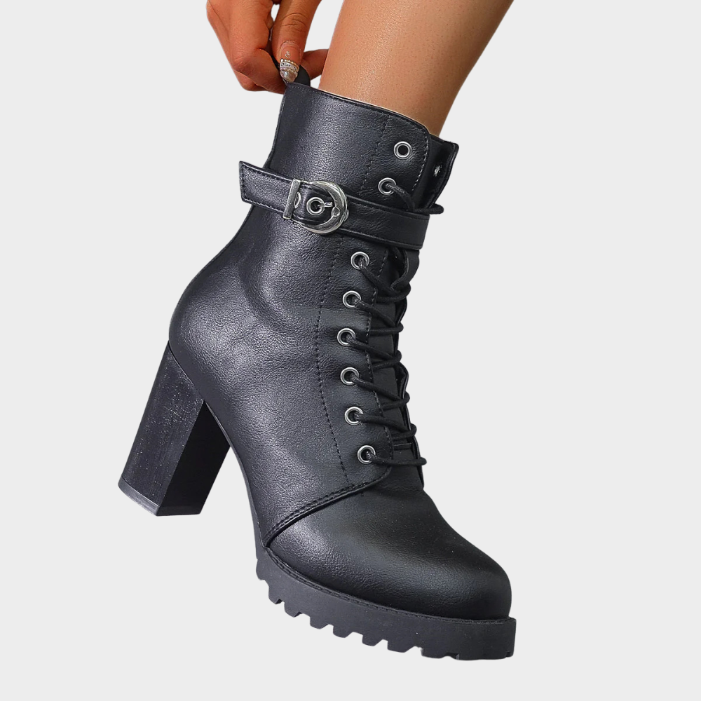 Black flared heel ankle boots with lace-up front, buckle strap, and chunky tread sole