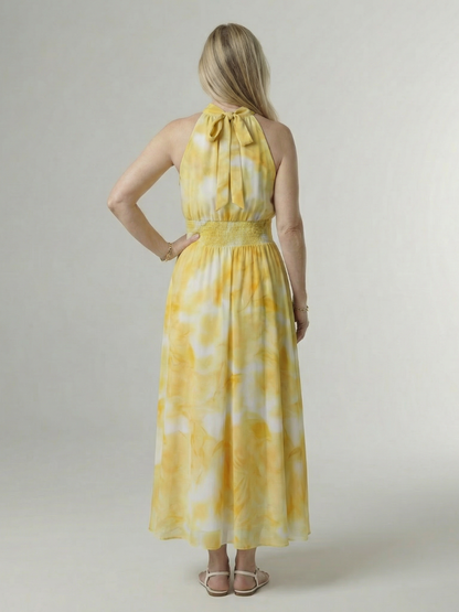 Yellow gathered halter midi dress back view with tied neck and smocked waist