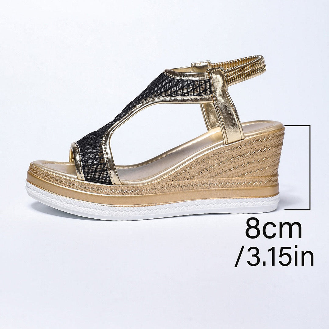 Dark mesh wedge sandals with gold T-strap and textured platform midsole