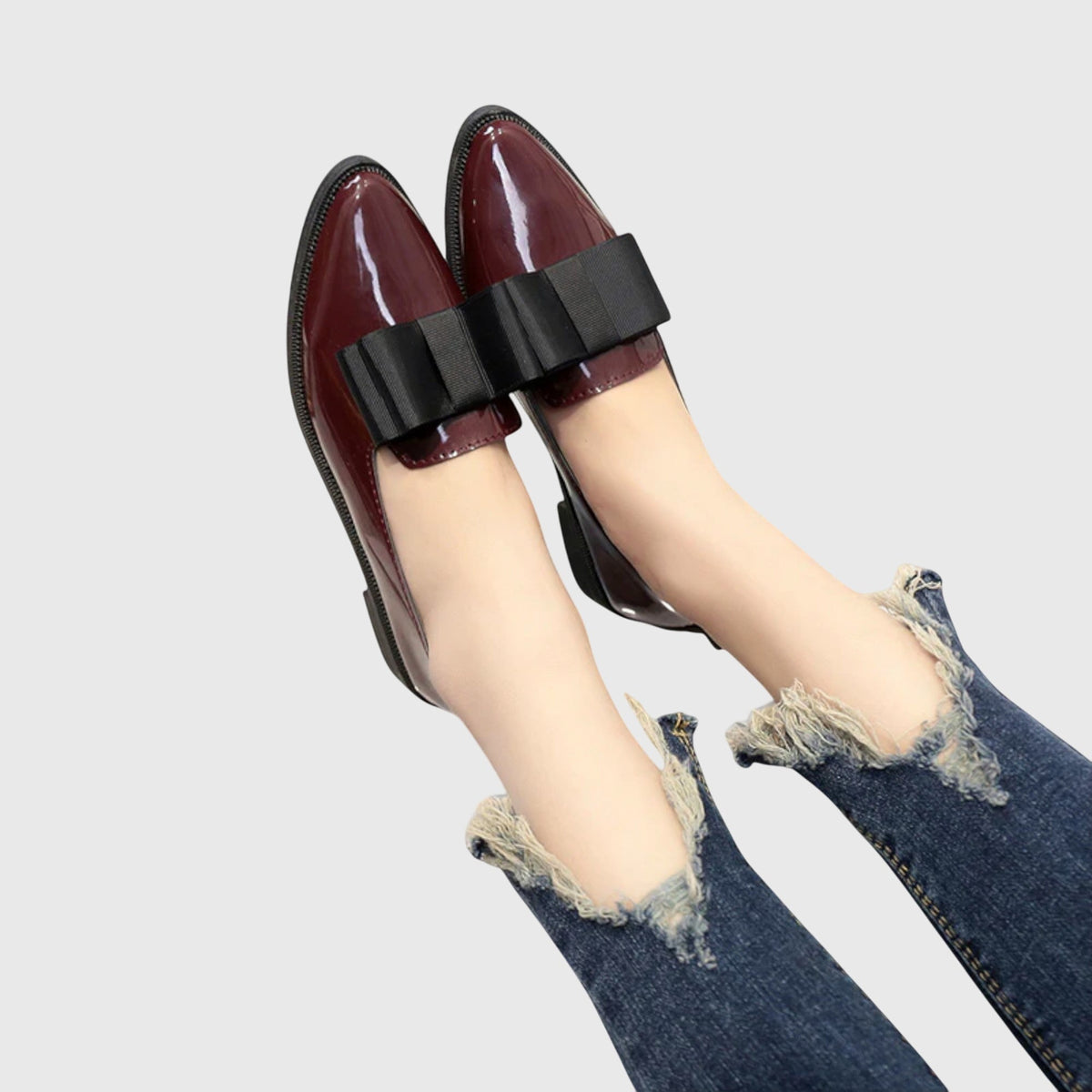 Burgundy patent loafer with wide black strap and rounded toe