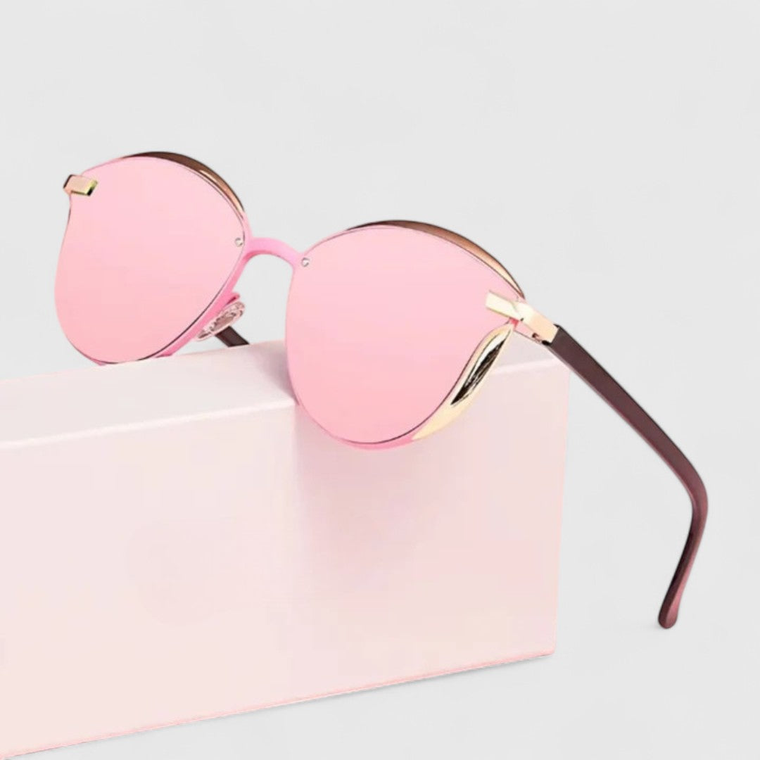 Pink mirrored round sunglasses with gold hinge detail and dark brown temples