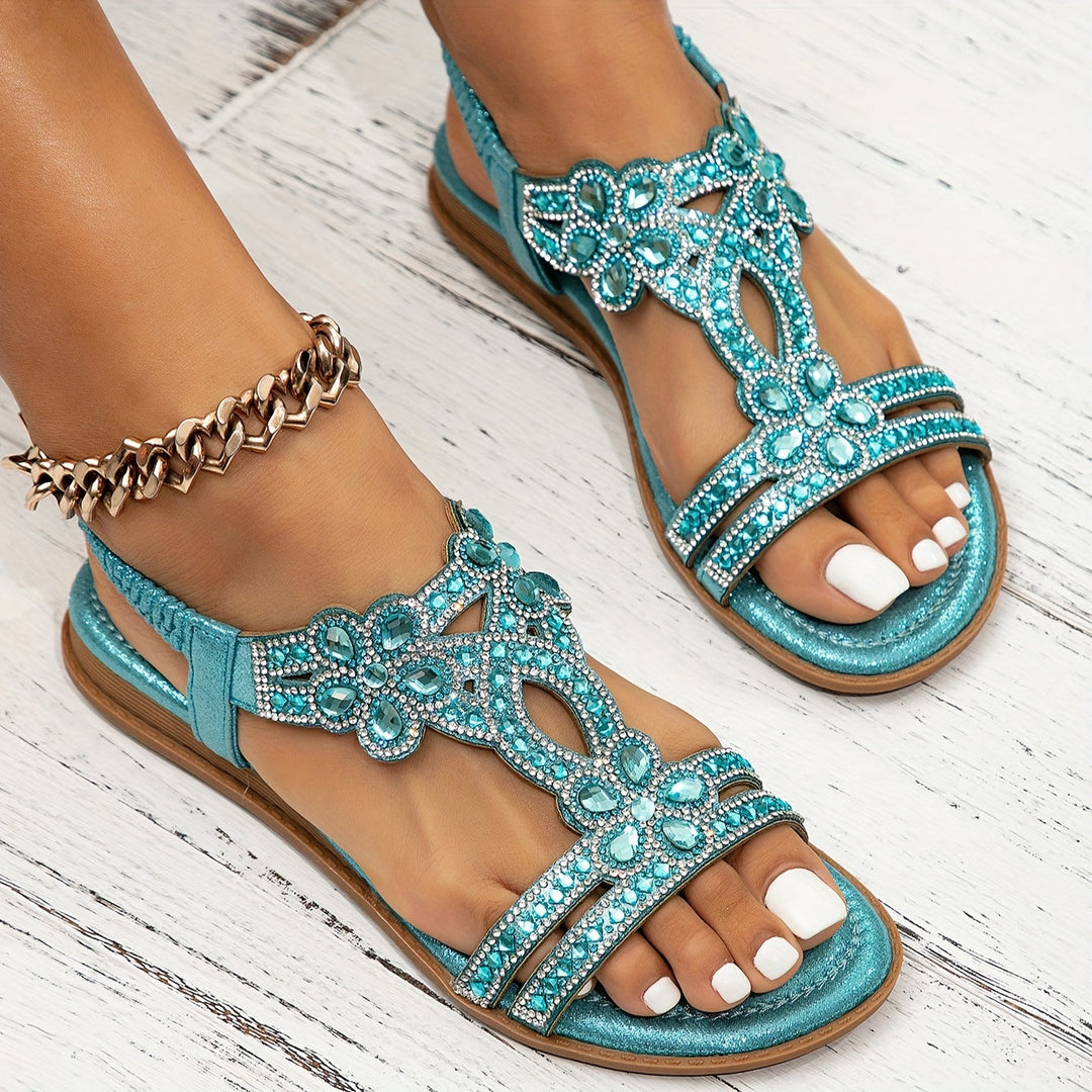 Teal orthopedic crystal sandals with ornate rhinestone straps and open toe, flat sole.