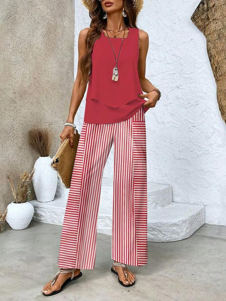 Red sleeveless blouse and wide-leg trousers with red-and-white vertical stripes