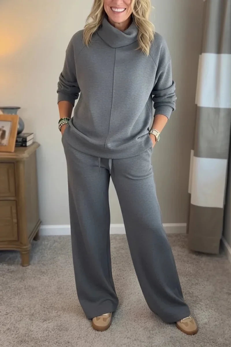 Grey coordinated zip-front hoodie top and wide-leg pants set.