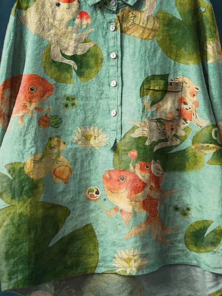 Teal long-sleeve button-up shirt close-up with fish, shell, and seaweed illustration