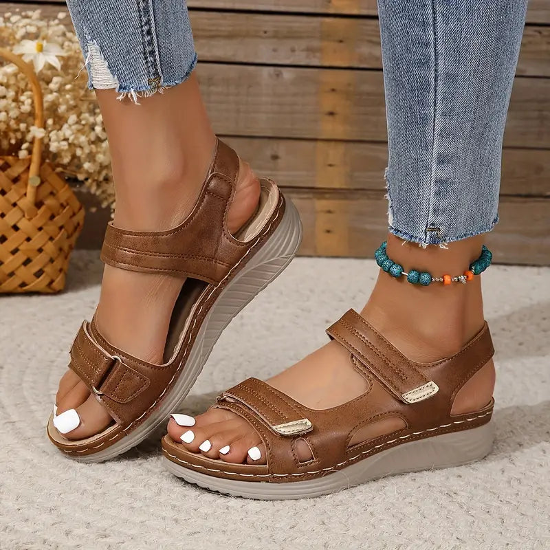 Brown orthopedic sandals with two hook-and-loop straps and cushioned wedge sole