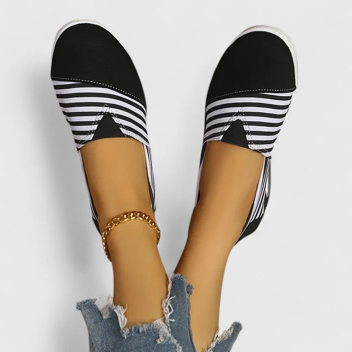 Anika orthopedic slip-on sneakers, black upper with white striped toe and cushioned sole