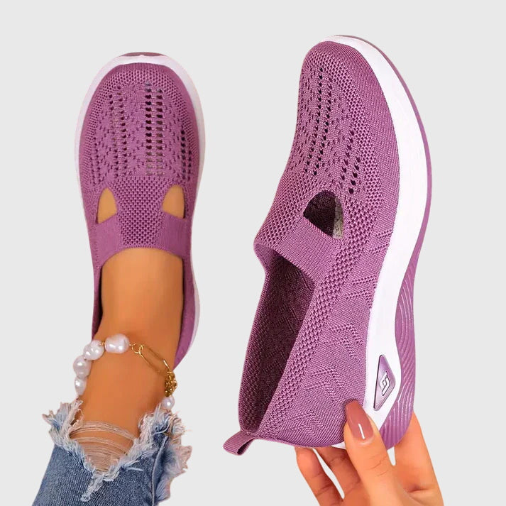 Purple slip-on orthopedic walking shoe, knit upper with open toe cutouts, white sole.