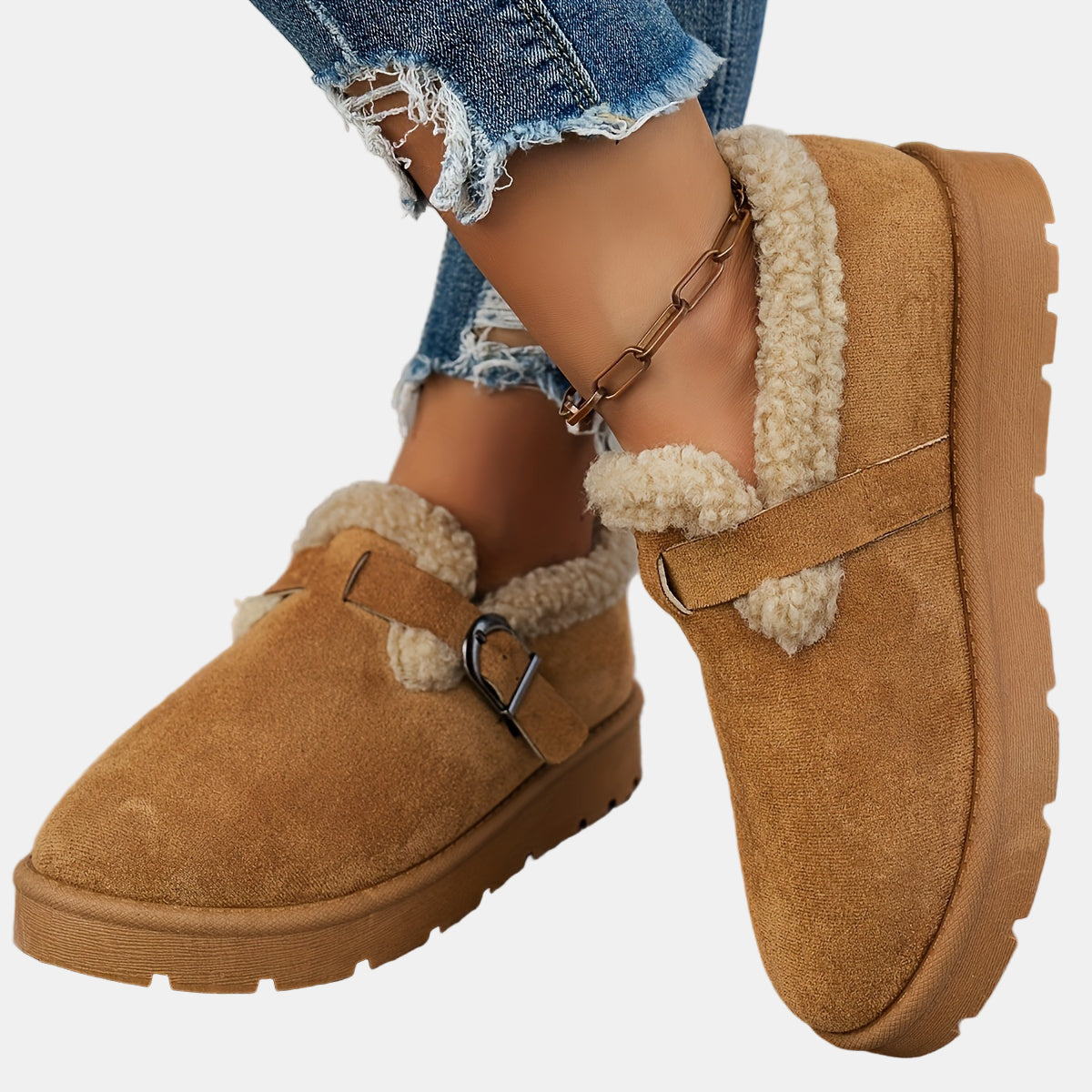 Brown fleece-lined ankle boots with buckled side strap and chunky lug sole