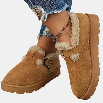 Brown fleece-lined ankle boots with buckled side strap and chunky lug sole