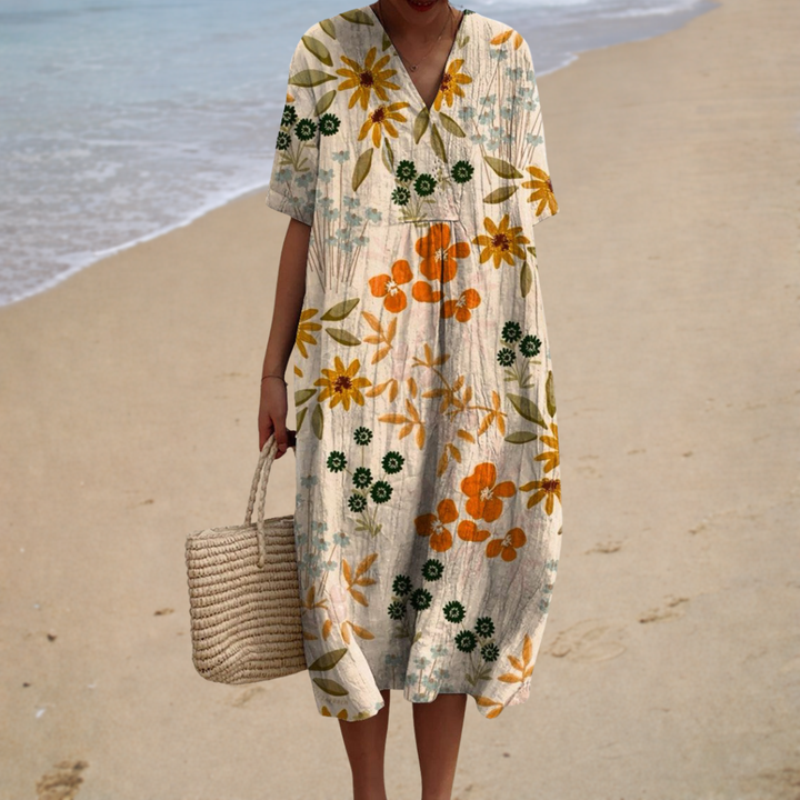 Floral summer dress with V-neck and short sleeves, cream base with orange, green prints