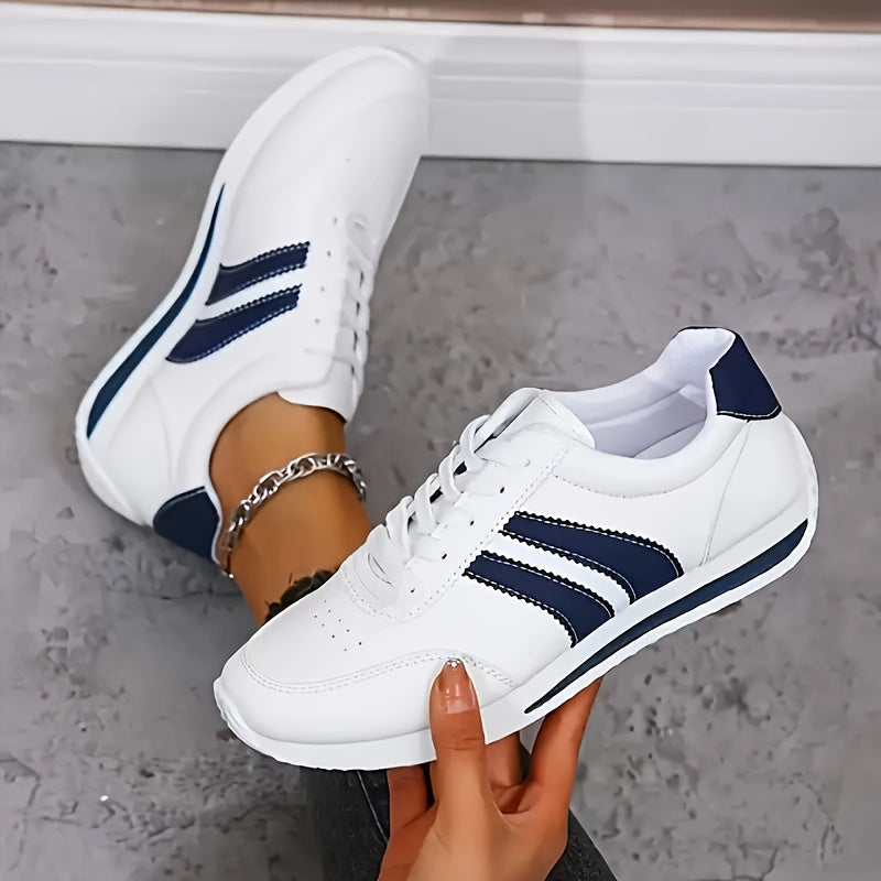 White lightweight orthopedic sneakers with navy stripes and lace-up front