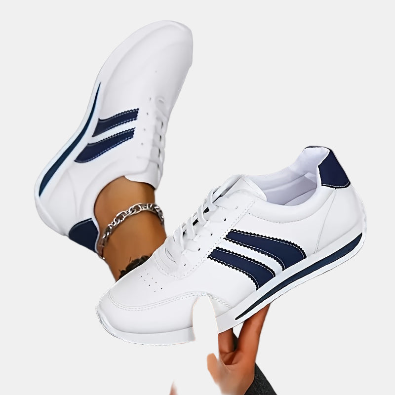 White orthopedic sneakers with navy stripe detailing and lace-up front
