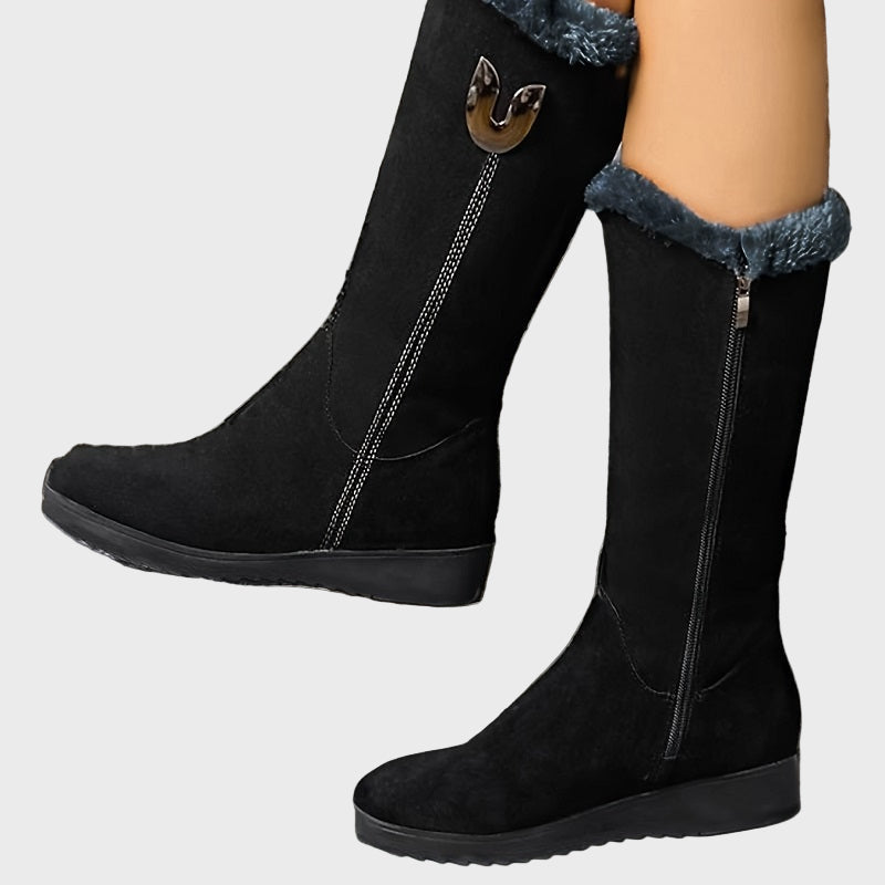 Black mid-calf boots with faux fur cuff, side zipper, and decorative buckle detail