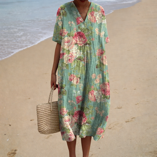 Floral summer dress with V-neck, short sleeves, and gathered waist in green with pink flowers
