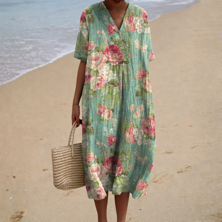 Floral summer dress with V-neck, short sleeves, and gathered waist in green with pink flowers