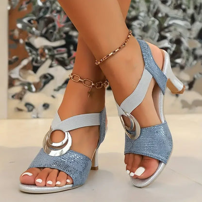 Blue orthopedic high heel sandal with wide ankle strap and silver buckle ornament
