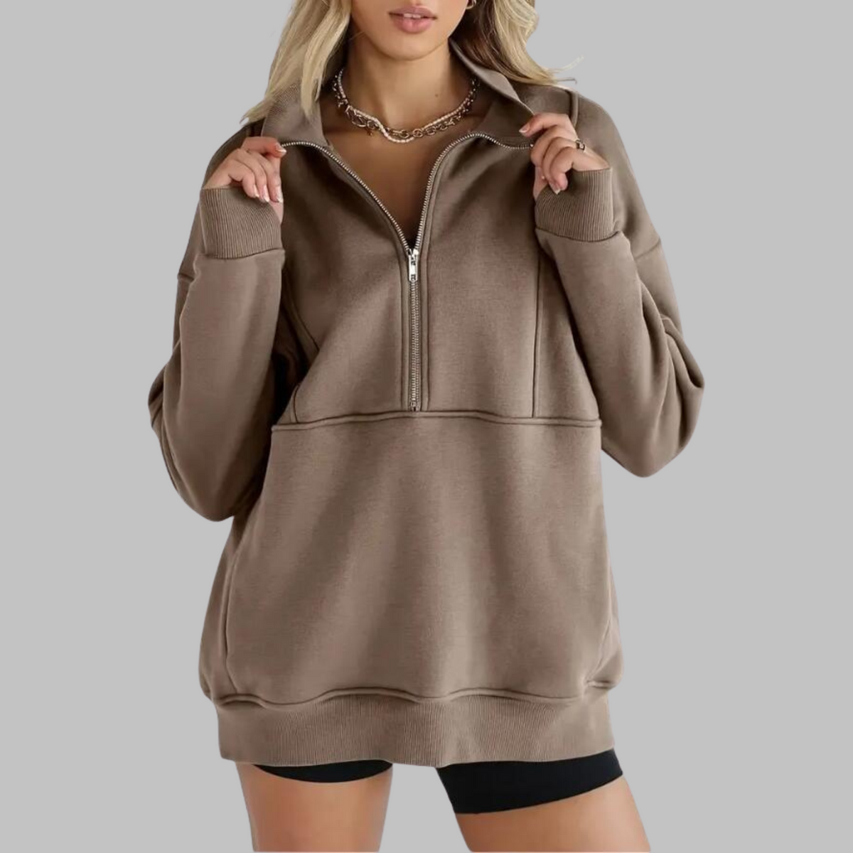 Taupe oversized half-zip long sleeve sweatshirt with ribbed cuffs, collar, and front pocket