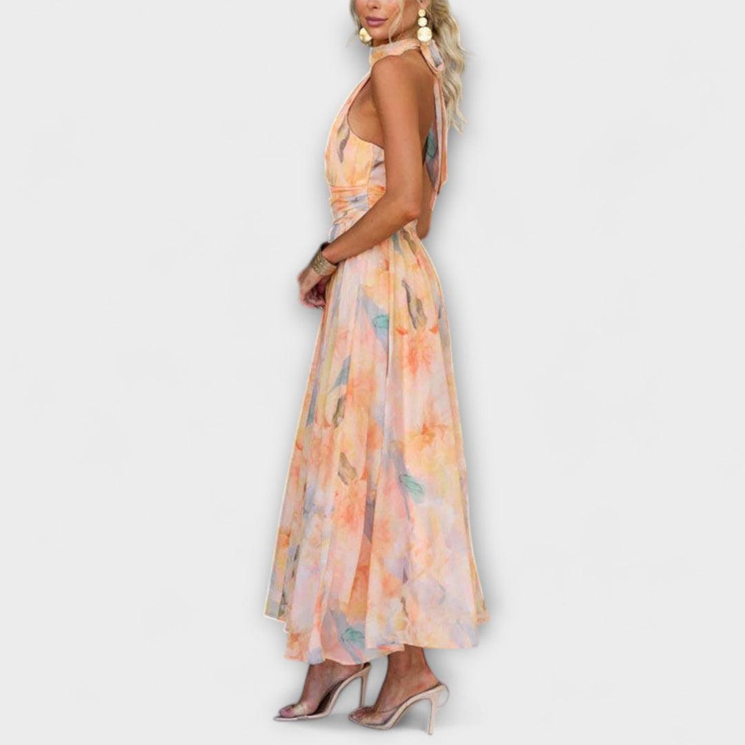 Maxi dress side view with halter neckline, sleeveless pastel floral print, flared hem