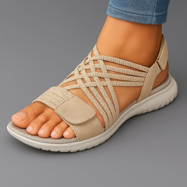 Beige orthopaedic sandals with woven lattice straps, open toe and cushioned sole.