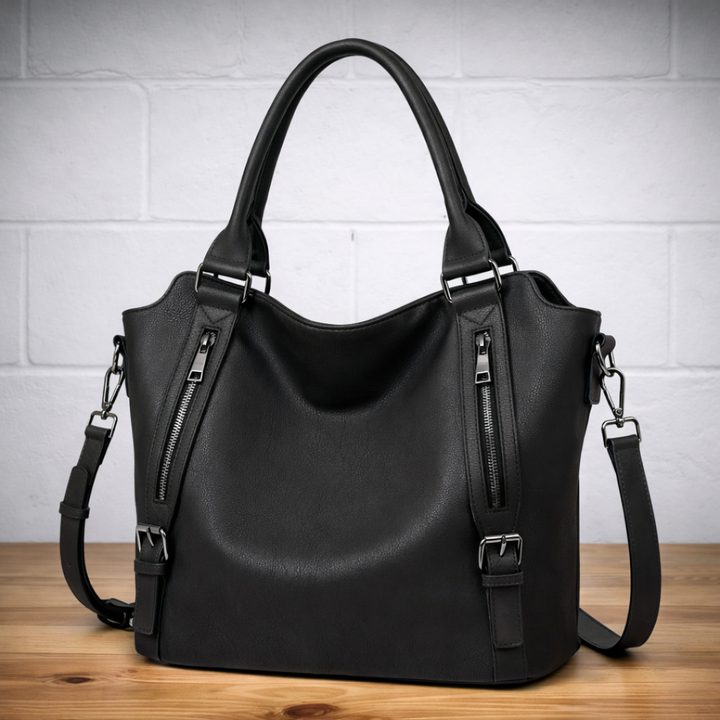 Black leather hobo tote bag with two top handles, dual zip pockets, and crossbody strap