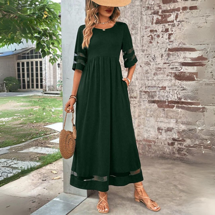 Green maxi dress with scoop neck, tiered waist, and striped 3/4 sleeve cutouts