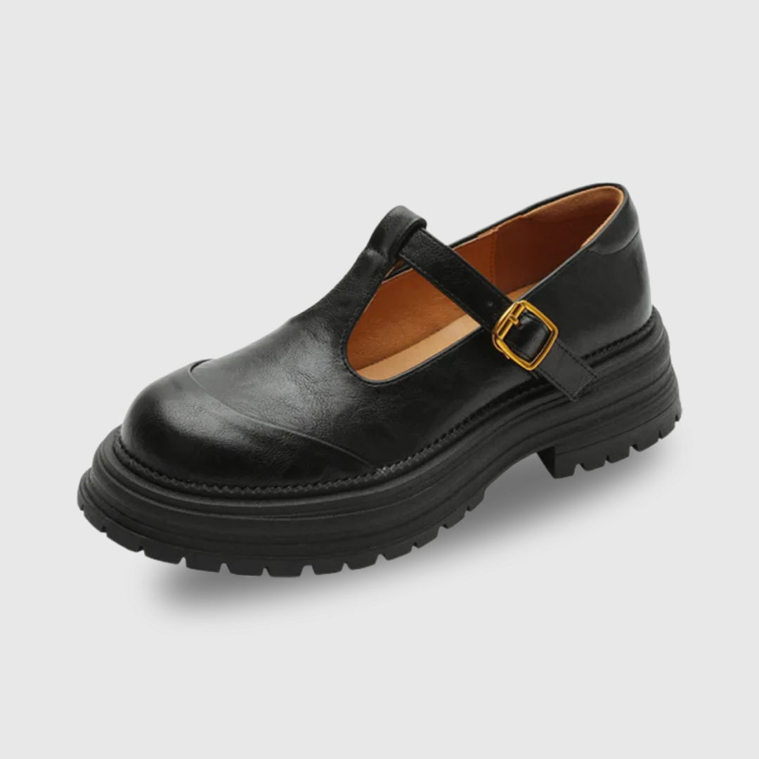 Black T-bar shoes with cutout strap, gold buckle, and chunky treaded sole