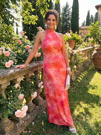 Orange halter-neck maxi dress with abstract print and sleeveless silhouette