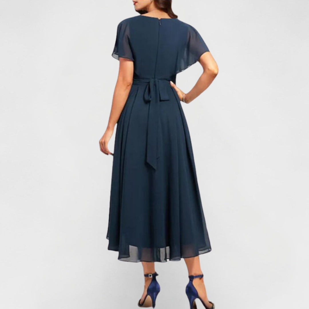 Navy V-neck maxi dress back view with short flutter sleeves and tied waist detail