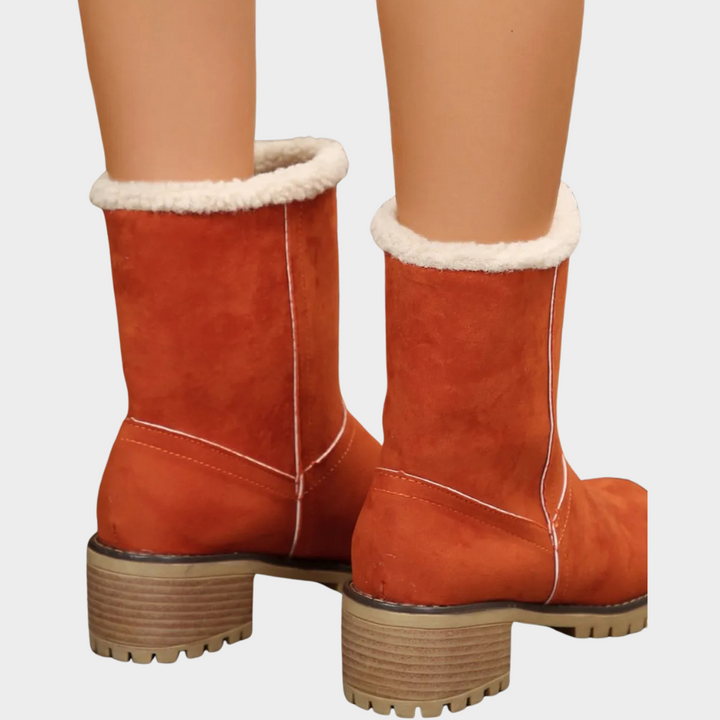 Orange suede pull-on winter boots with faux-sherpa lining at collar and stacked block heel