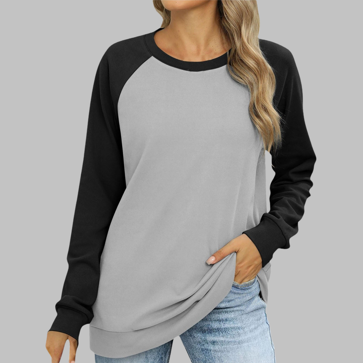 Two-tone raglan sweatshirt, round neck, long sleeves; light gray body, black sleeves