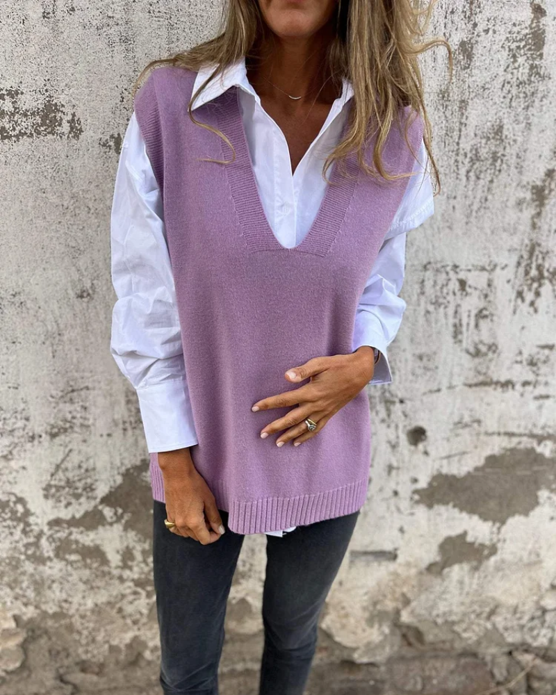 Purple knit sweater vest over a white button-down, V-neck sleeveless with ribbed hem.