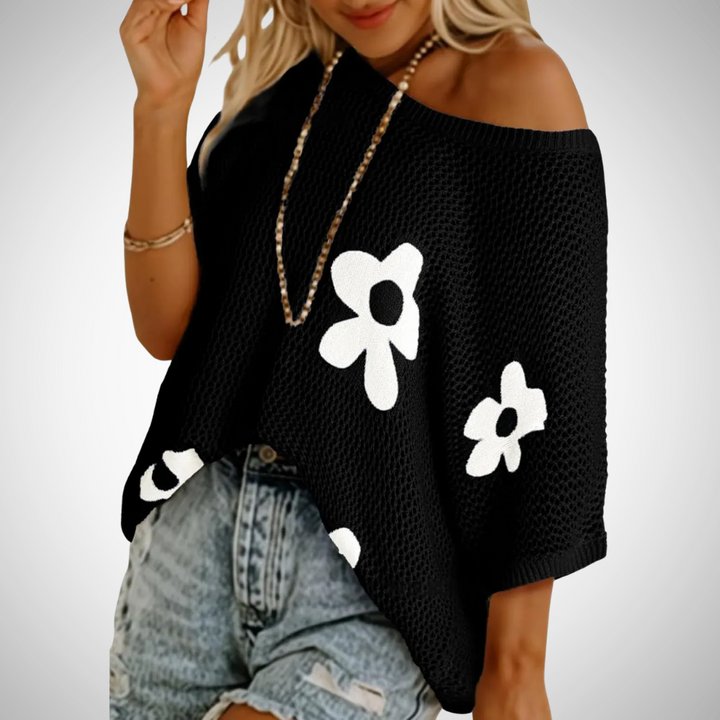 Black off-shoulder crochet top with flower appliques and wide knit hem