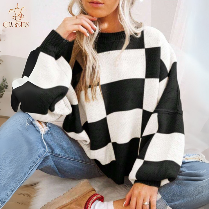 Black and white checkered crewneck long-sleeve knit sweater with ribbed cuffs