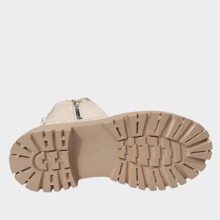 Beige comfort boot outsoles with deep tread and side zipper entry