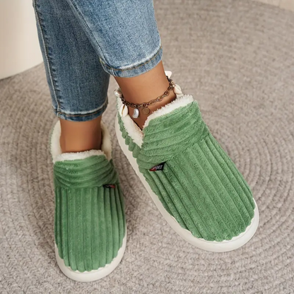 Green comfort slippers with ribbed fabric, white trim, and chunky white soles