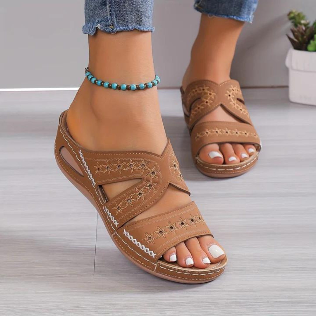 Orthopedic sandals with brown wide straps and open toe, decorative stitched panels, cushioned sole