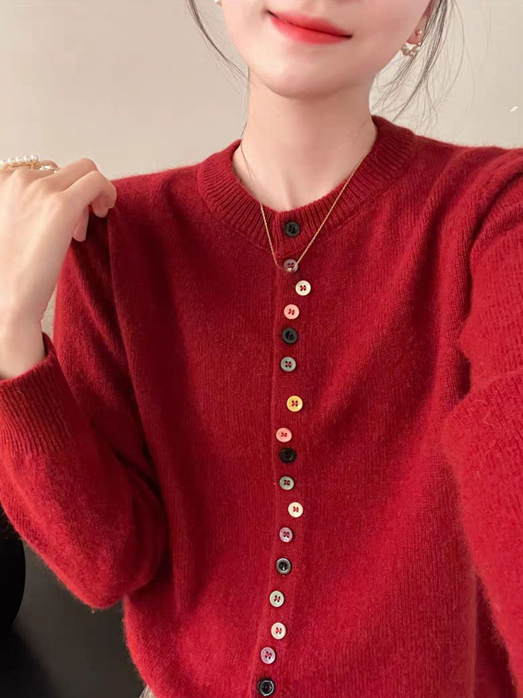 Red knit cardigan with button front and ribbed crew neck, long sleeves