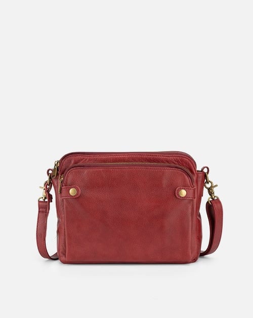 Red sleek crossbody bag with zip top, front pockets, and adjustable shoulder strap