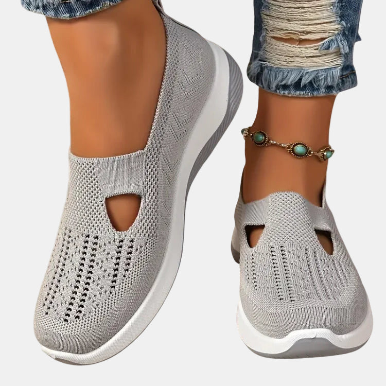 Light gray slip-on orthopedic walking shoe, knit upper with open toe cutouts, white sole.