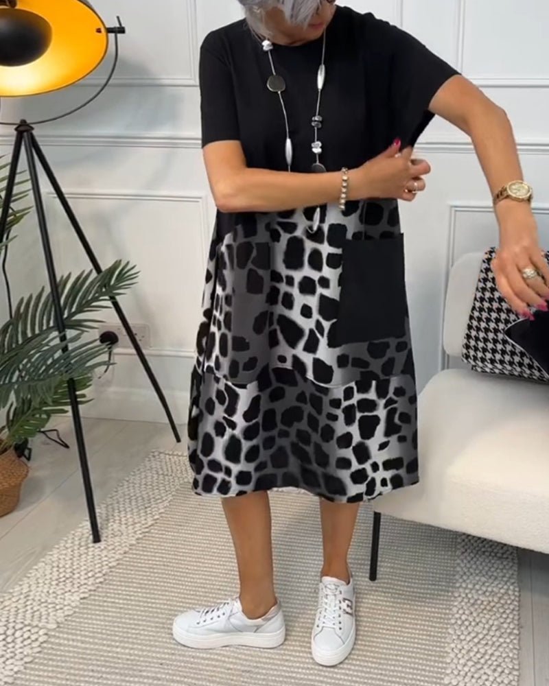 Women's black midi dress with leopard print panel, short sleeves, relaxed A-line