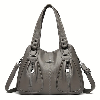 Women’s casual shoulder bag in grey with top handles and crossbody strap.