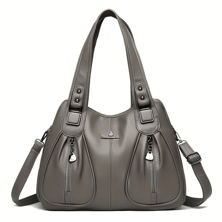 Women’s casual shoulder bag in grey with top handles and crossbody strap.