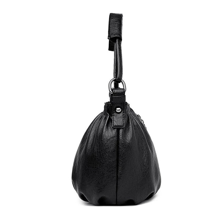 Black multi-layer handbag bottom view with short loop handle and gathered body shape