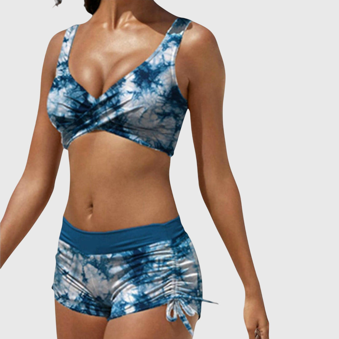 Blue tie-dye bikini set with V-neck wrap top and ruched drawstring swim shorts