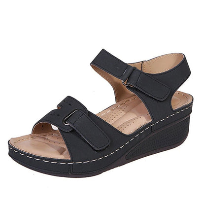 Women’s black wedge sandals with two adjustable straps and perforated footbed